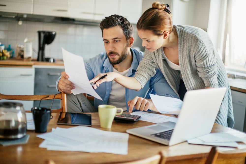 concerned couple reviewing paperwork