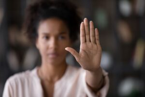 woman holding hand up