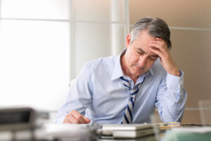 worried man looking at finances