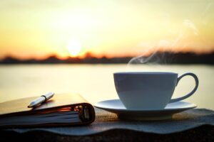 coffee and notepad overlooking sunrise