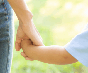 parent holding child's hand