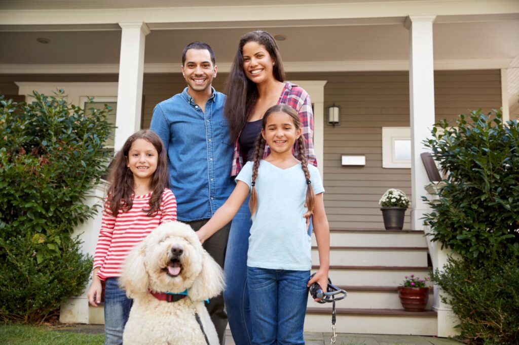 family in front of home