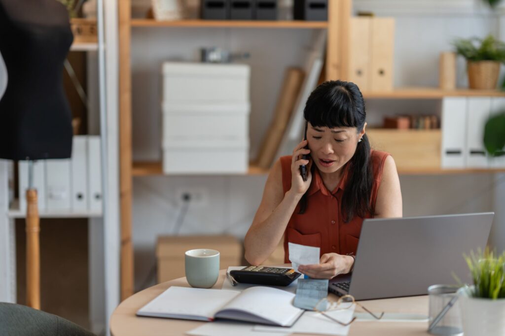 business owner looking concerned through paperwork