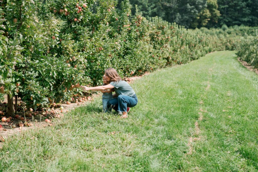 mother daughter picking apples